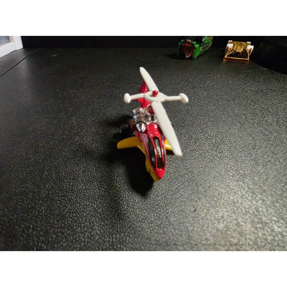 Lot of 4 loose Hot Wheels vehicles in pre-owned condition.
